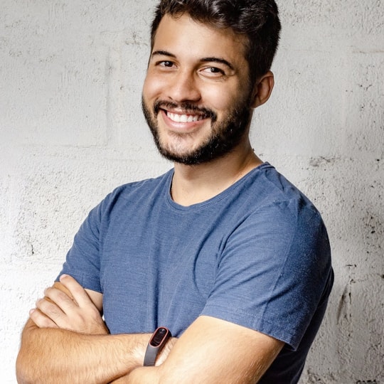 a man smiling with his arms crossed